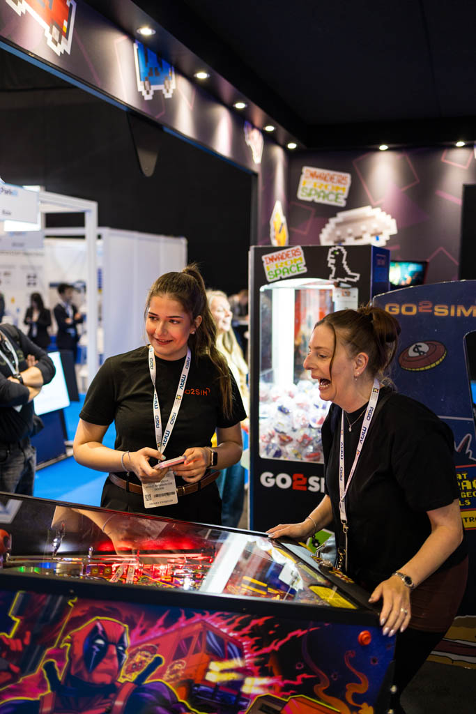 2 women playing pinball